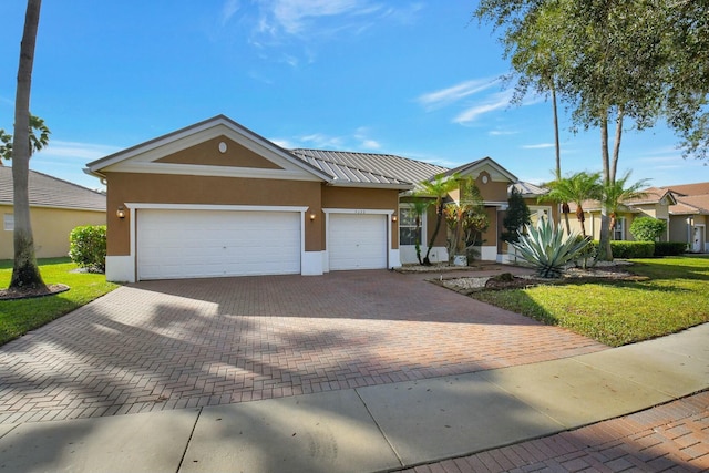 view of front of property featuring a garage and a front lawn