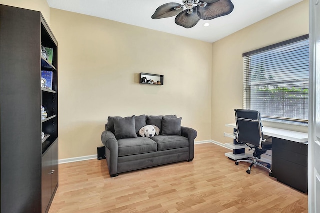 office with light hardwood / wood-style flooring and ceiling fan