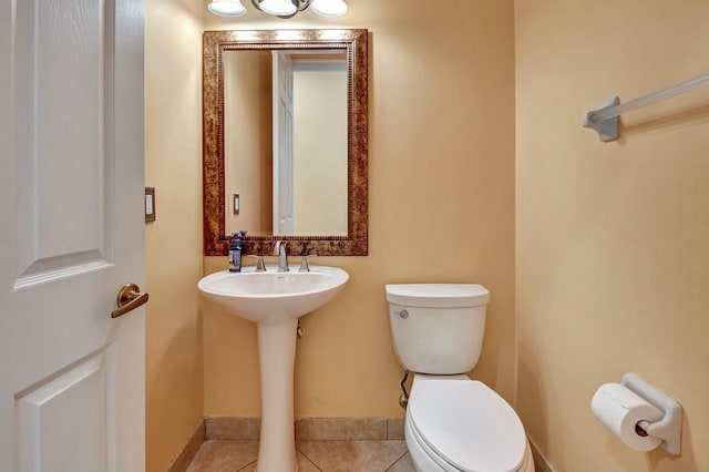 bathroom with tile patterned flooring and toilet