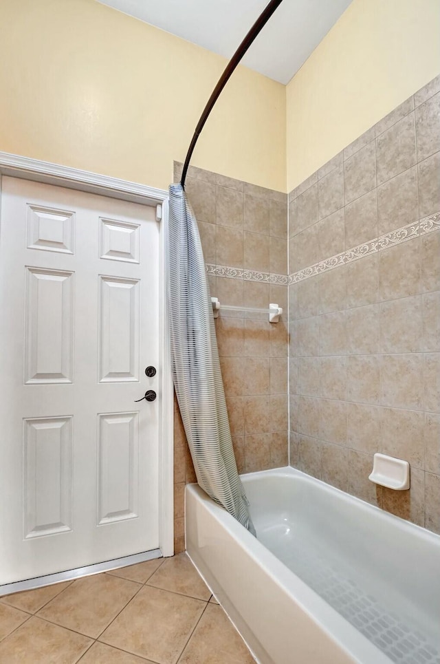 bathroom featuring tile patterned flooring and shower / bathtub combination with curtain