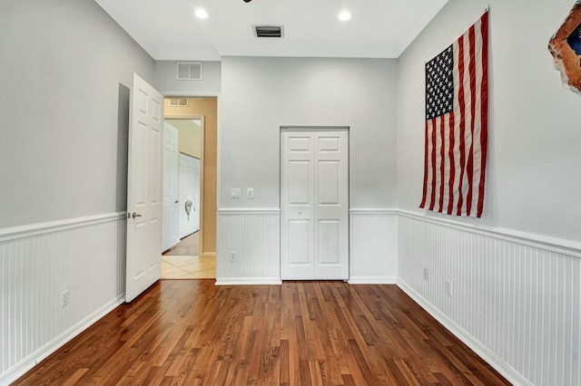 unfurnished bedroom featuring dark hardwood / wood-style floors and a closet