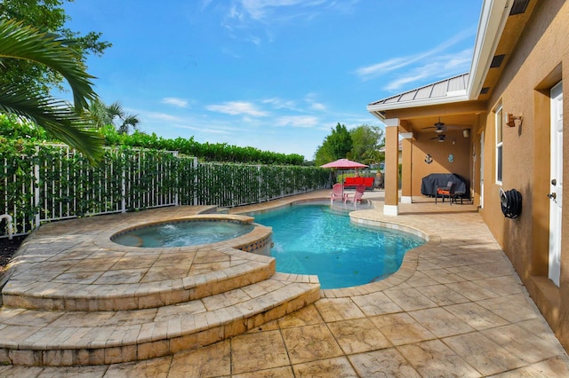 view of swimming pool with area for grilling, an in ground hot tub, and a patio