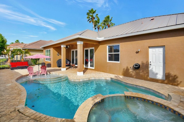 view of pool with an in ground hot tub and a patio