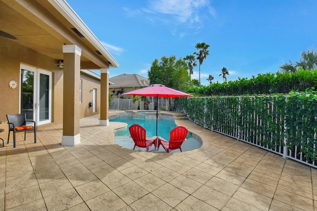 view of swimming pool featuring an in ground hot tub, french doors, and a patio