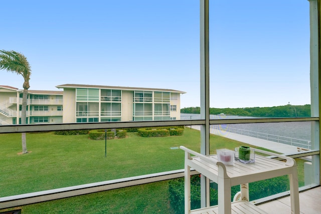 unfurnished sunroom featuring a water view