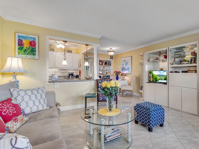 living room featuring ornate columns, crown molding, and light tile patterned floors