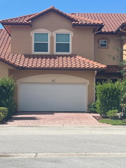 mediterranean / spanish-style house featuring a garage