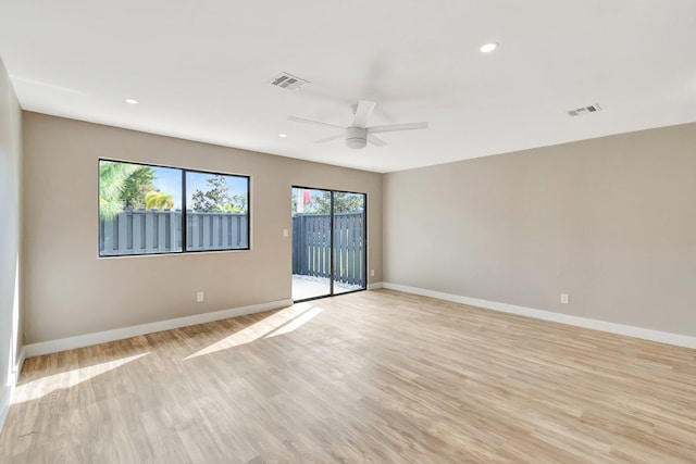 unfurnished room with ceiling fan and light hardwood / wood-style floors