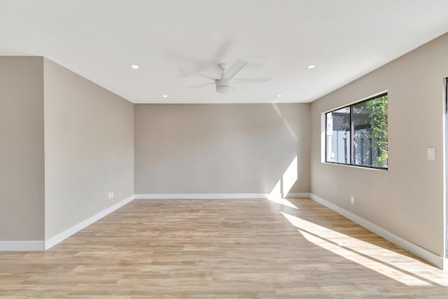 spare room with light hardwood / wood-style floors and ceiling fan