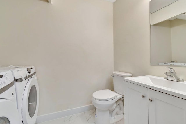 bathroom with washer and clothes dryer, vanity, and toilet