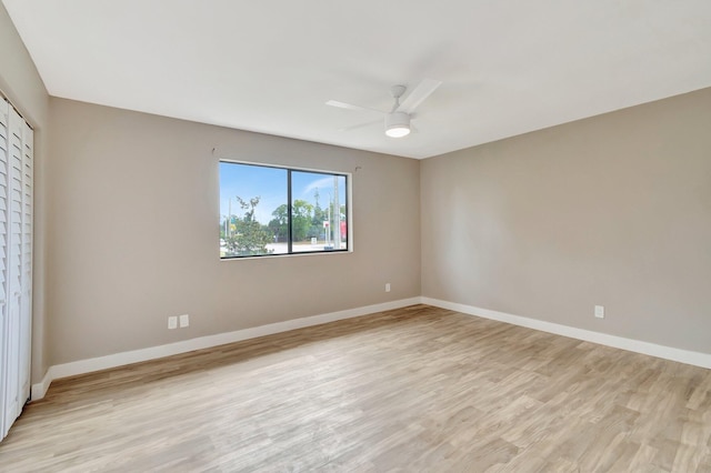 unfurnished bedroom with a closet, light hardwood / wood-style floors, and ceiling fan