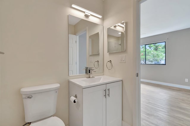 bathroom featuring hardwood / wood-style floors, vanity, and toilet