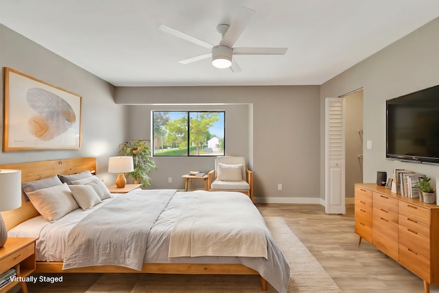 bedroom with ceiling fan and light hardwood / wood-style flooring