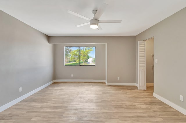 empty room with ceiling fan and light wood-type flooring