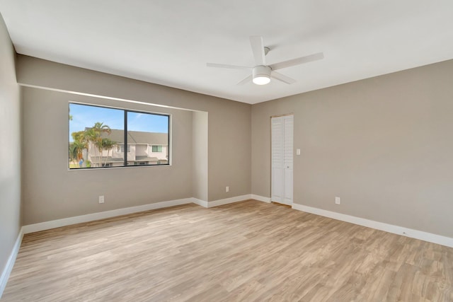 spare room with light hardwood / wood-style floors and ceiling fan