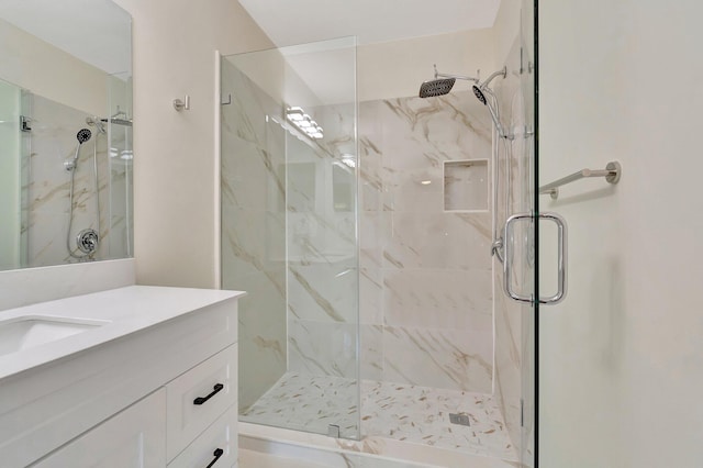 bathroom featuring vanity and an enclosed shower