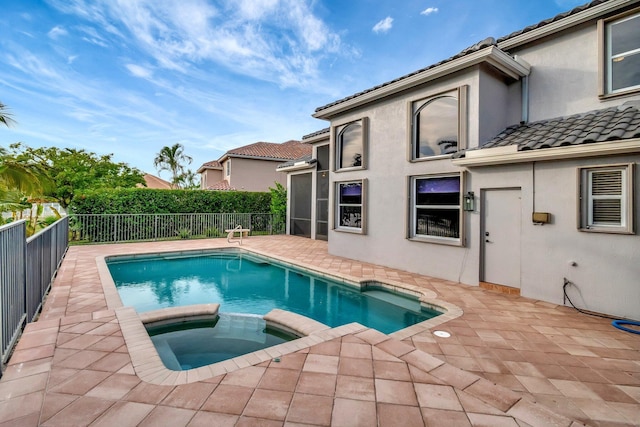 view of pool featuring an in ground hot tub and a patio