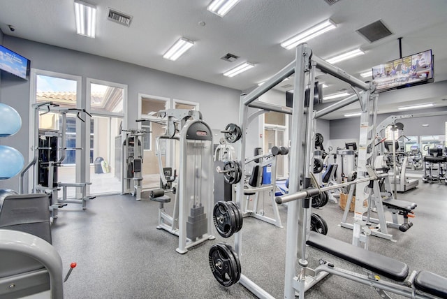 workout area with a textured ceiling