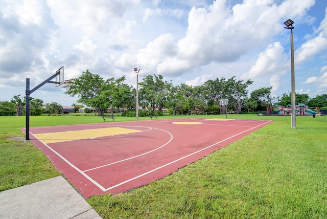 view of sport court featuring a playground and a yard