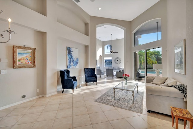 tiled living room with a towering ceiling and ceiling fan