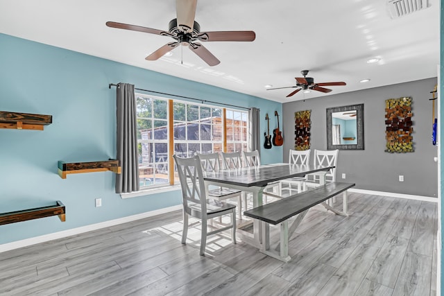 unfurnished dining area featuring ceiling fan and light wood-type flooring