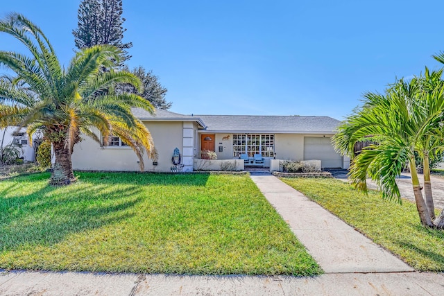 ranch-style home with a garage and a front lawn