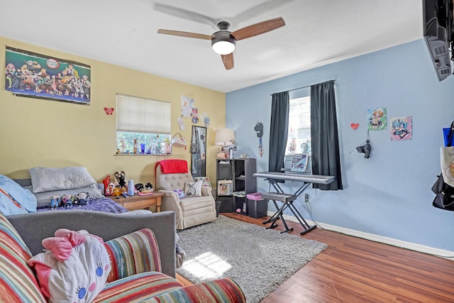 living room with hardwood / wood-style flooring and ceiling fan