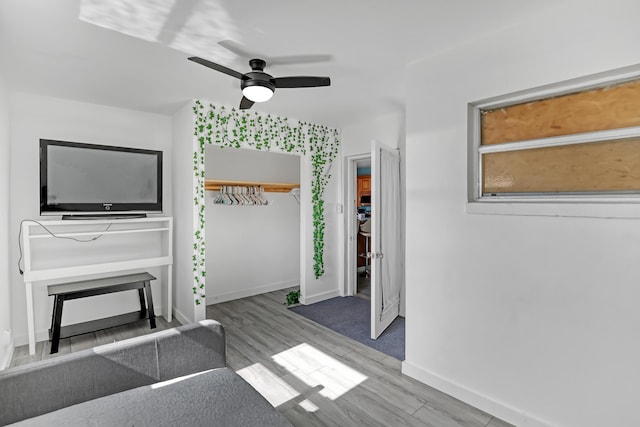 unfurnished living room with ceiling fan and wood-type flooring