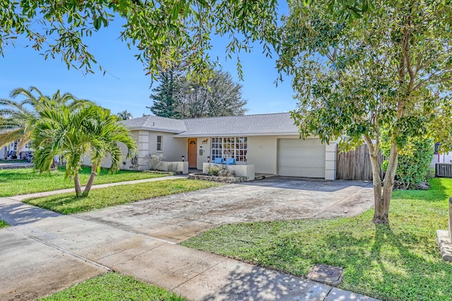 ranch-style home featuring a front lawn and a garage