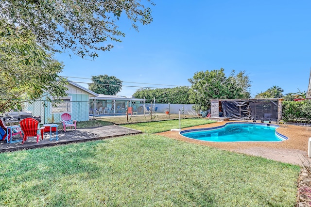 view of swimming pool featuring a yard and a patio area