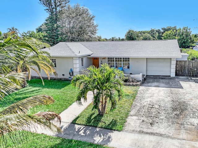 single story home featuring a front yard and a garage