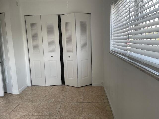 unfurnished bedroom with light tile patterned floors