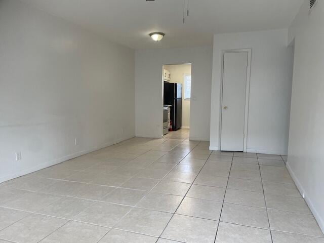 spare room with light tile patterned floors