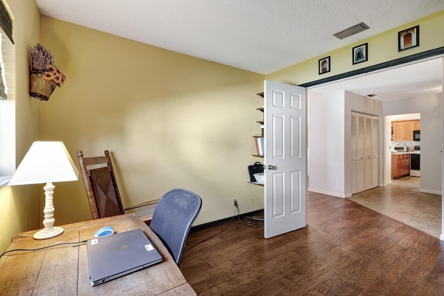 office area featuring dark hardwood / wood-style floors and a textured ceiling