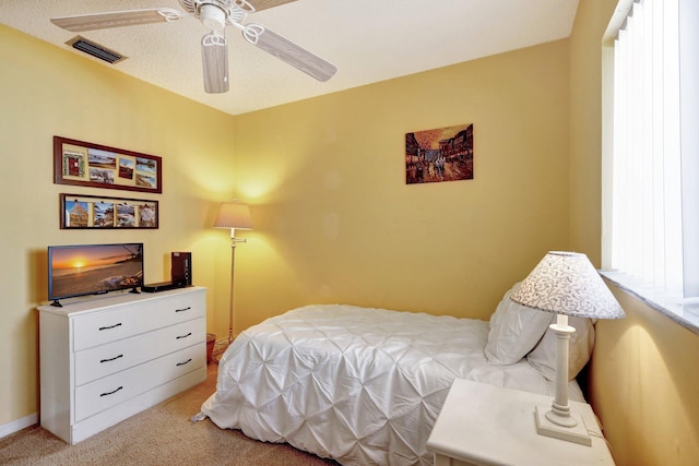 bedroom featuring light colored carpet and ceiling fan