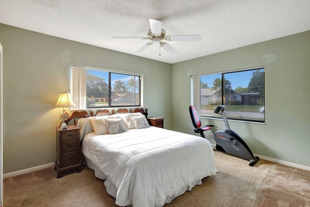 carpeted bedroom with a textured ceiling and ceiling fan