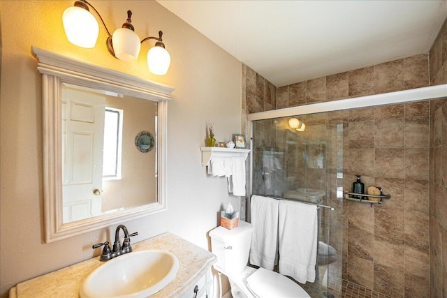 bathroom with vanity, toilet, and an enclosed shower