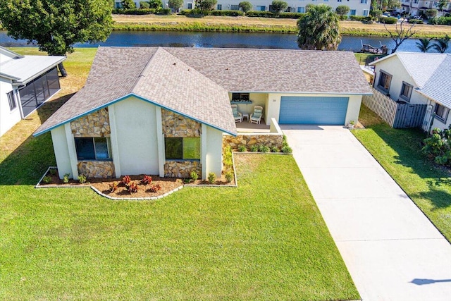 ranch-style house featuring a front lawn and a water view