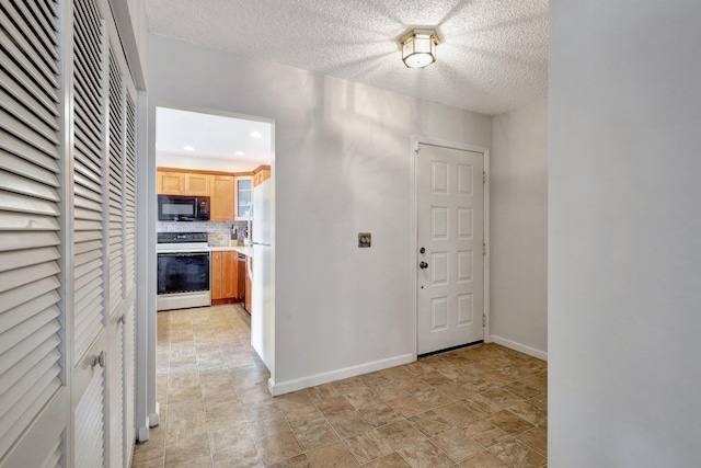 entryway with a textured ceiling