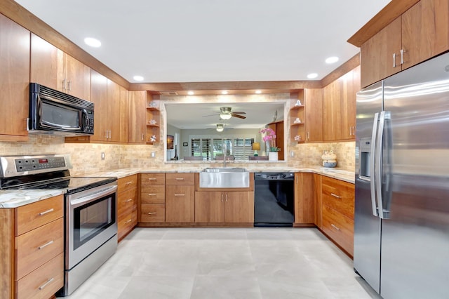 kitchen featuring black appliances, backsplash, kitchen peninsula, and sink