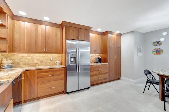 kitchen featuring decorative backsplash, stainless steel fridge, light stone countertops, and black dishwasher