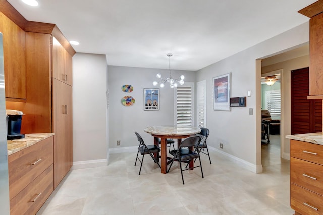 dining room featuring ceiling fan with notable chandelier