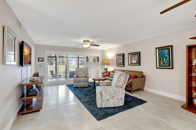 living room with ceiling fan and light tile patterned flooring