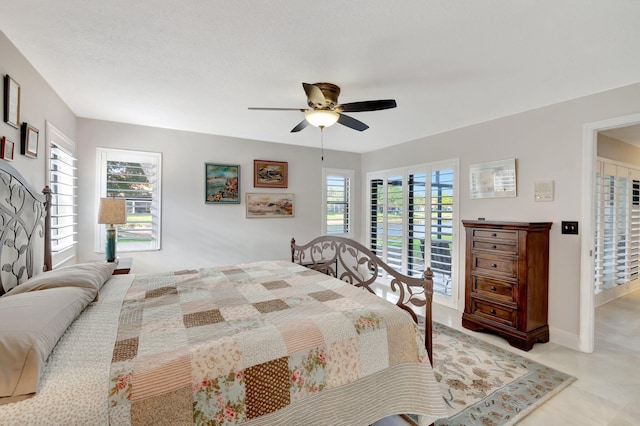 bedroom featuring ceiling fan, access to exterior, and multiple windows