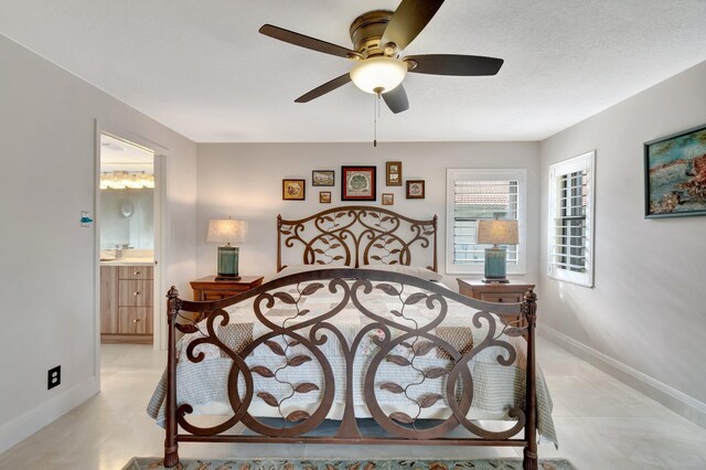 bedroom with ceiling fan, a textured ceiling, and ensuite bath