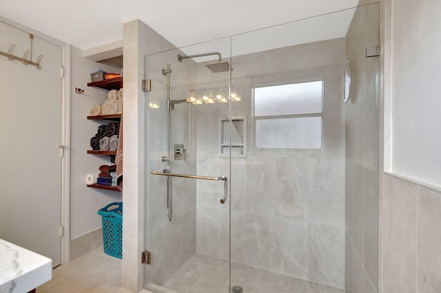 bathroom featuring a shower with shower door