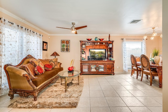 tiled living room with ceiling fan with notable chandelier and crown molding