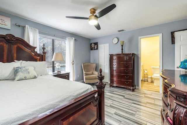 bedroom with ceiling fan, light hardwood / wood-style flooring, and ensuite bathroom