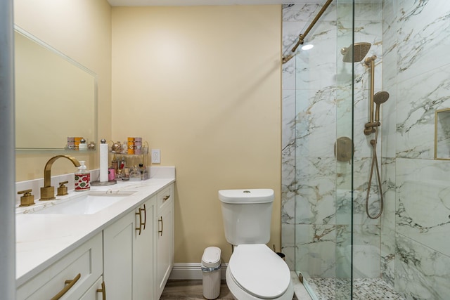 bathroom featuring vanity, hardwood / wood-style flooring, toilet, and an enclosed shower