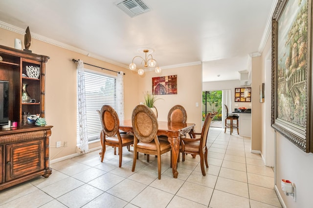 dining room featuring a chandelier, light tile patterned floors, and crown molding